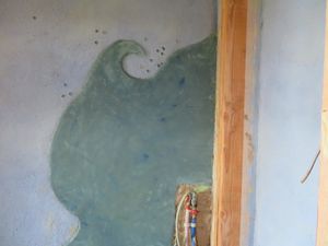 Ici les toilettes, le mur derrière le lavabo et derrière la baignoire...